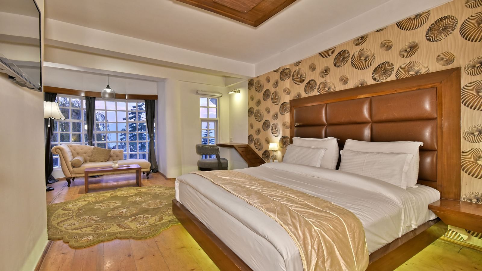 Spacious suite featuring a bedroom with a living area at DLS Hillcrest Resort, Shimla.